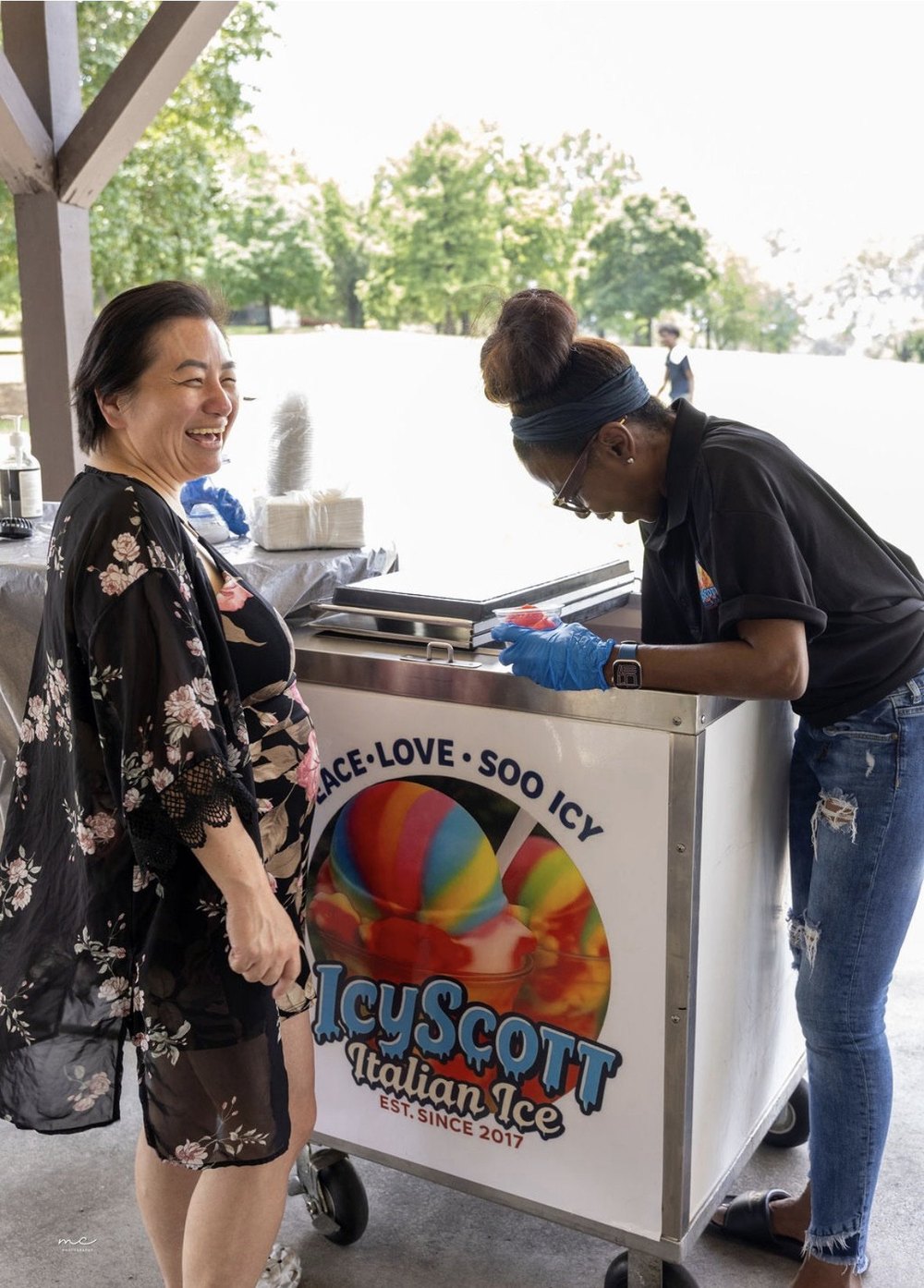 Serving Italian ice to a guest at an outdoor event