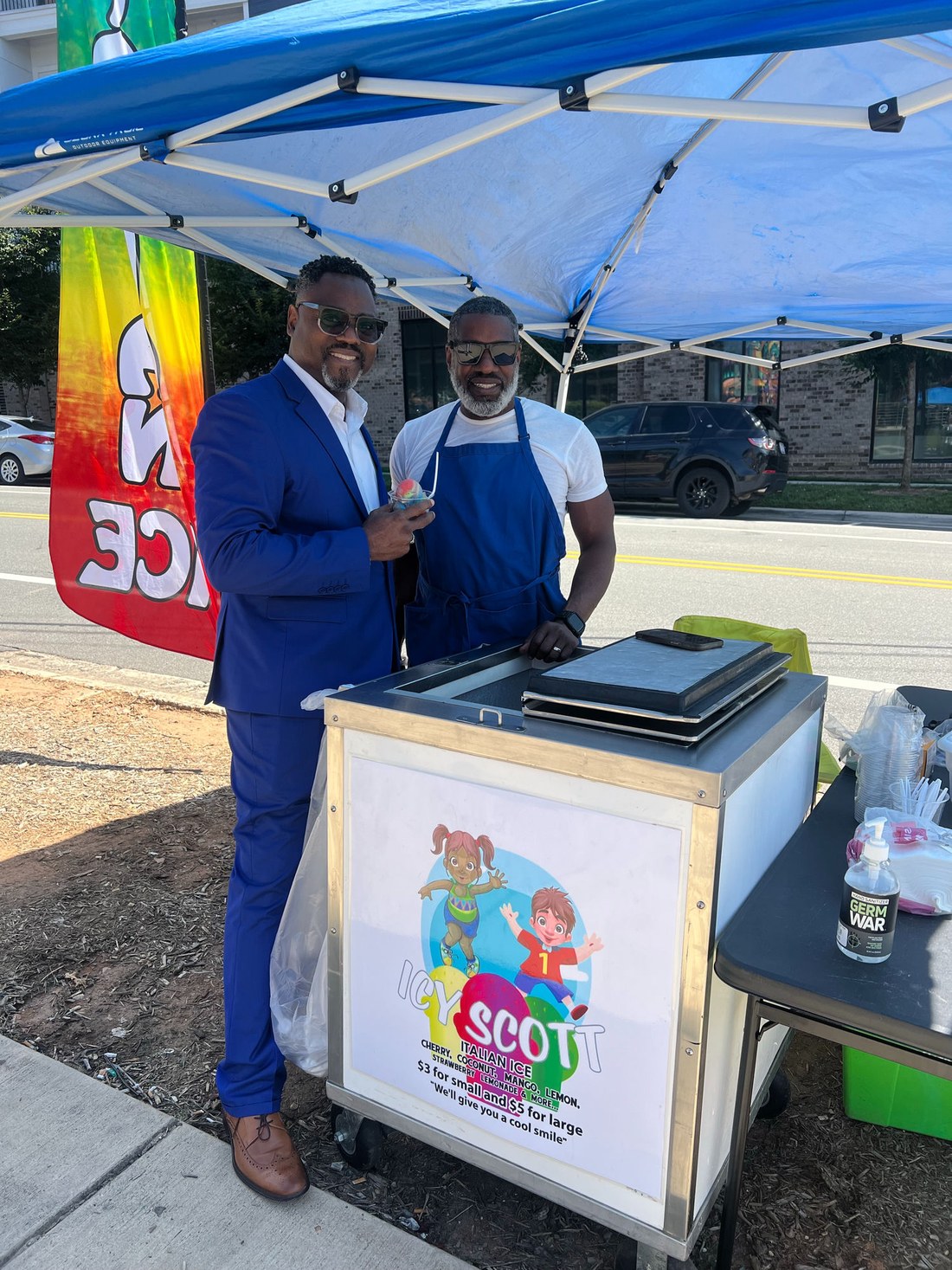 The IcyScott team serving Italian ice at a community gathering